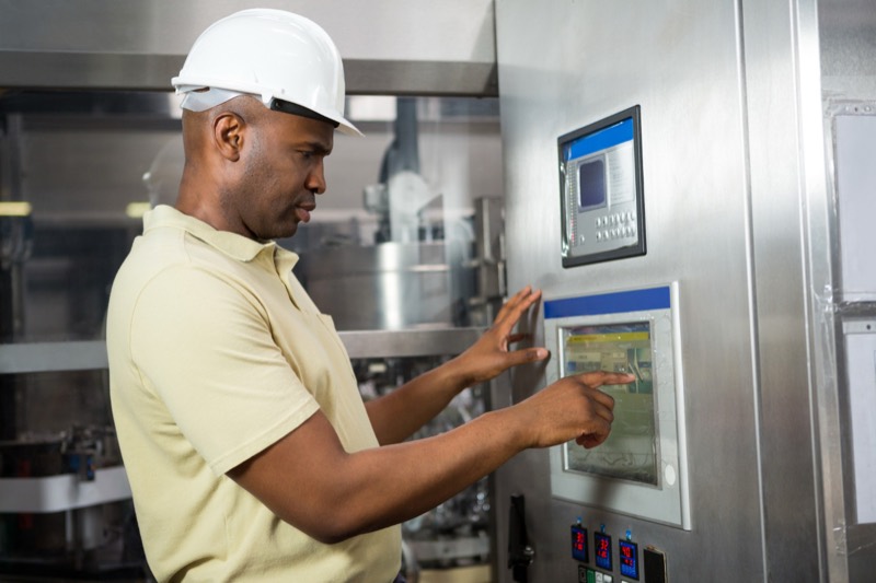 Technician operating hospital equipment